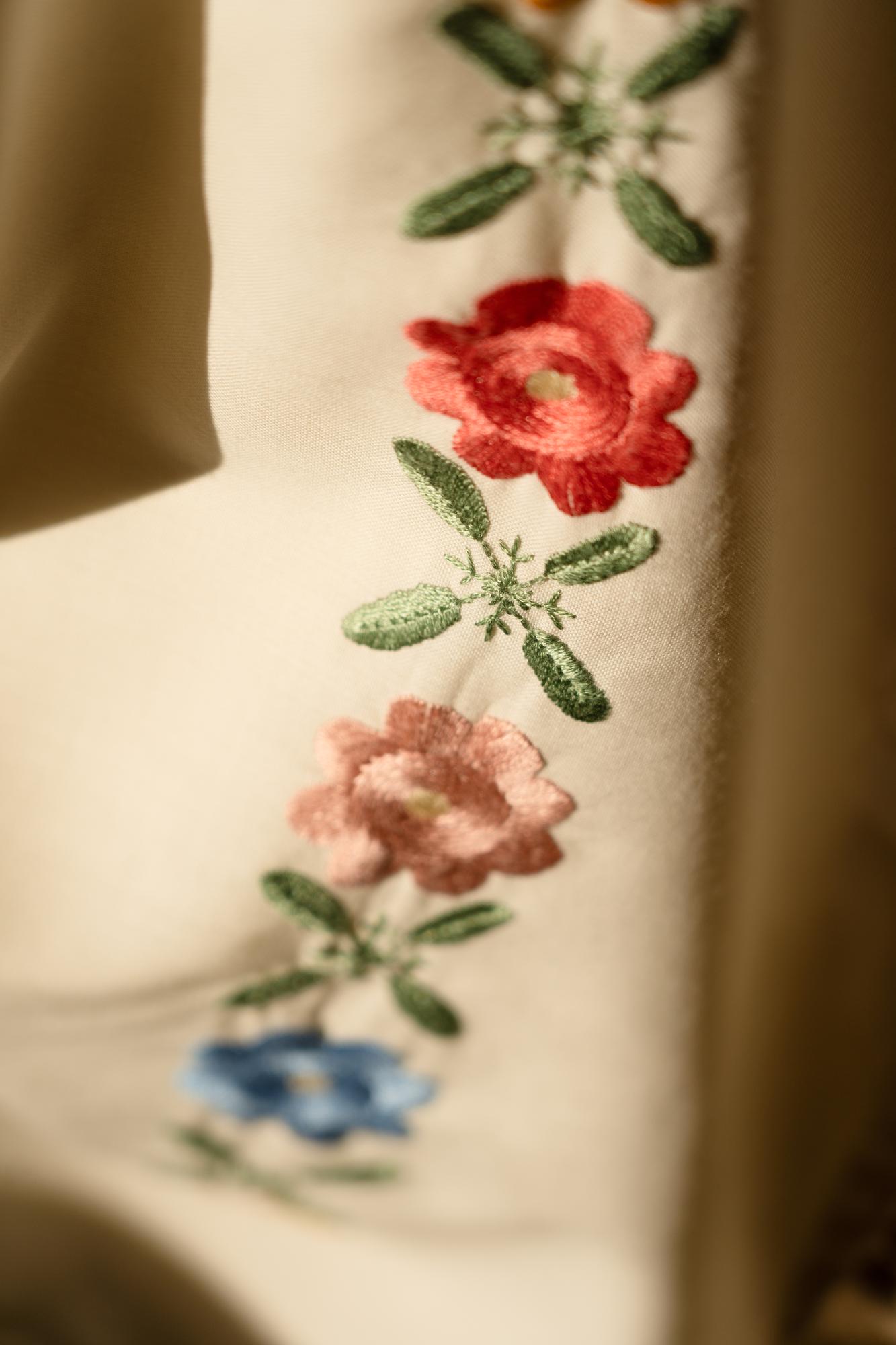Close-up embroidered floral motif on linen